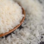milled-rice-bowl-wooden-spoon-black-cement-floor-664d8ebb-focus-0-0-375-240